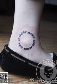 simple round English tattoo on the ankle