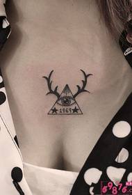 triangle eye antler black and white chest tattoo