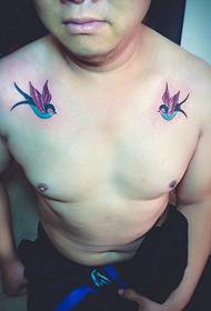 a pair of small swallow tattoo designs on the chest is very eye-catching