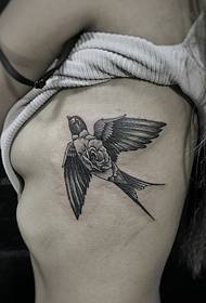 a small swallow tattoo pattern on the side of the waist