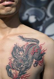 holding a big dream Young man chest unicorn tattoo