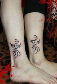 a pair of phoenix totem works on a beautiful couple's feet