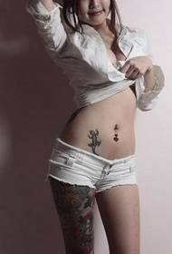 Picture of a beautiful woman showing a tattoo in a sultry pose