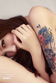 Arm tattooed beauty picture in bikini at home
