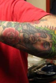 Arm colored jesus portrait and flower tattoo pattern