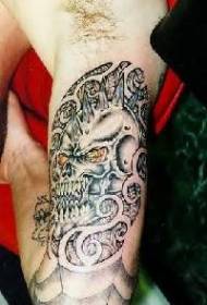 Black devil skull tattoo pattern on the arm