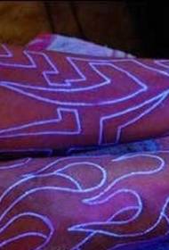 Fluorescent totem tattoo on the arm