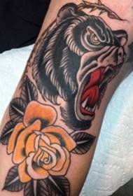 Traditional style black bear and yellow rose tattoo on arm
