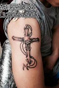 Handsome cross tattoo on the big arm