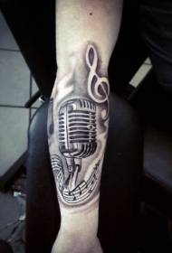 Simple design of black and white microphone and note arm tattoo pattern