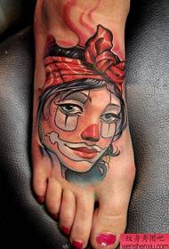 un tatouage de portrait de clown sur le cou-de-pied