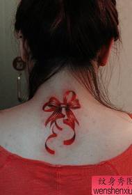 Girl with a colorful bow tattoo on the back