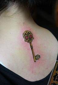Girl's favorite key tattoo with a skull