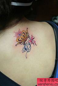 Beautiful back with beautiful colored crown and bow tattoo pattern