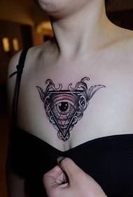El tatuaje geométrico del tatuaje del ojo en el escote es muy sexy
