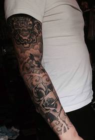 Men's black and white totem flower arm tattoo tattoo