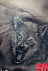 a domineering wolf head tattoo on the chest