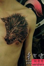 A handsome and fierce wolf head tattoo on the chest of a boy