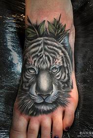a domineering tiger tattoo on the instep