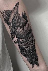 a lone eagle tattoo standing on a dead branch