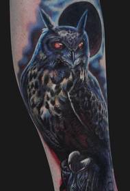an owl tattoo on the calf