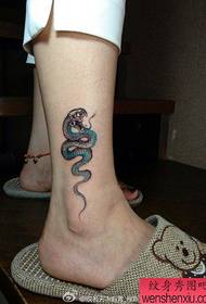 girl legs A popular small snake tattoo pattern