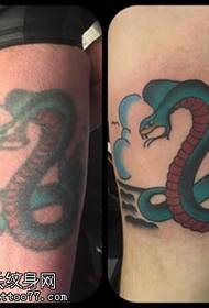 green snake tattoo pattern on the leg