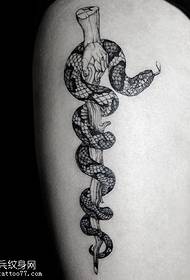 a snake tattoo on the thigh
