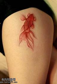 a red goldfish tattoo pattern in the leg
