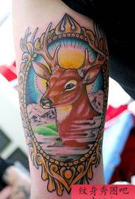 gros bras à l'intérieur d'un motif de tatouage de cerf