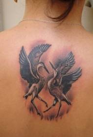 Two dancing cranes tattoos on the back