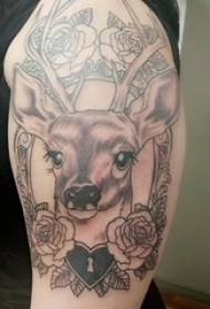 Girl's arm on black gray thorn plant flowers and small animal deer tattoo pictures