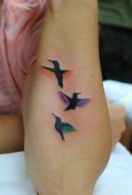 Small bird tattoo with different color wings