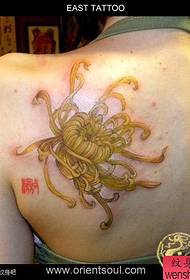 Beautiful girl chrysanthemum tattoo on the back of the girl