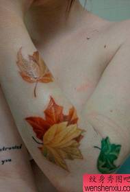 Girl child arm beautiful colored maple leaf tattoo pattern