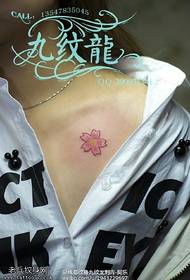 Small cherry blossom tattoo on the shoulder