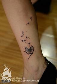 Small fresh dandelion tattoo pattern on the legs
