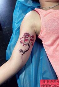 Beautiful female lotus tattoo pattern on the inside of the girl's arm