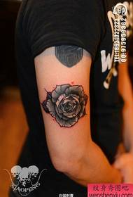 A popular rose tattoo pattern on the arm