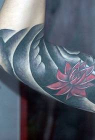 Arm black background and red lotus tattoo pattern