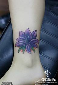 Beautiful lily tattoo on the ankle