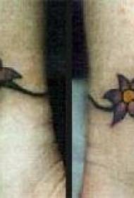 Female wrist colored small flower tattoo pattern