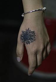 Hand with a personalized sun flower tattoo pattern
