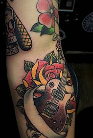 Guitar pattern tattooed by flowers