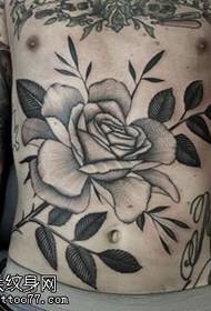 Rose tattoo pattern with a thorn on the abdomen