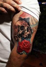 Arm colored red rose with skull tattoo pattern
