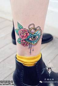 Eye rose tattoo on the ankle