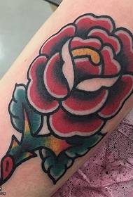 Flaming rose tattoo on arm