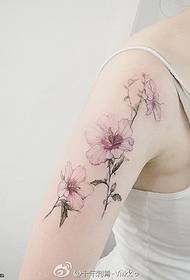 Fresh floral tattoo on the big arm