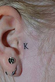 English letter K tattoo next to the right ear